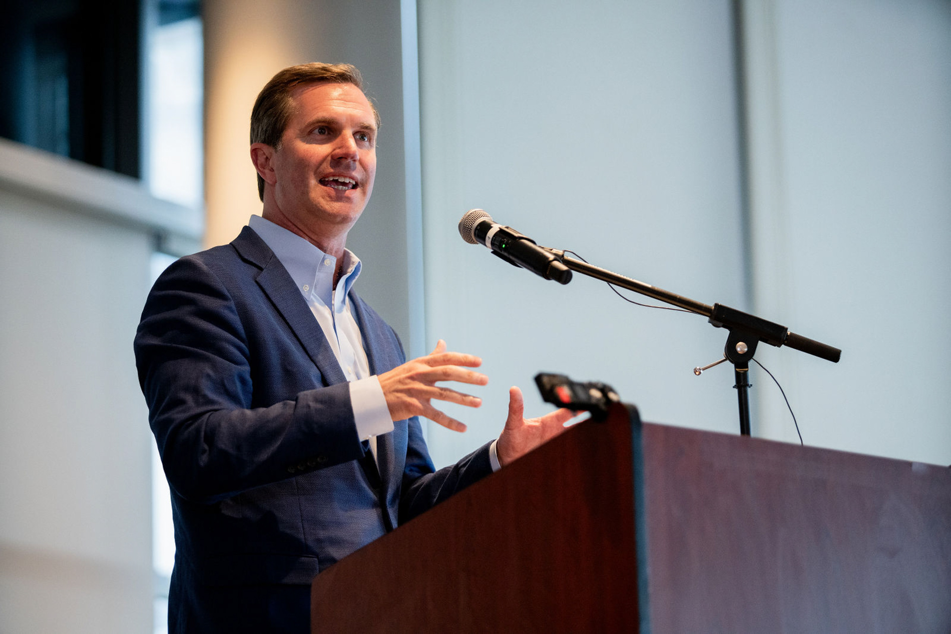 Louisville outdoor event — guests laughing and eating under tent at reception